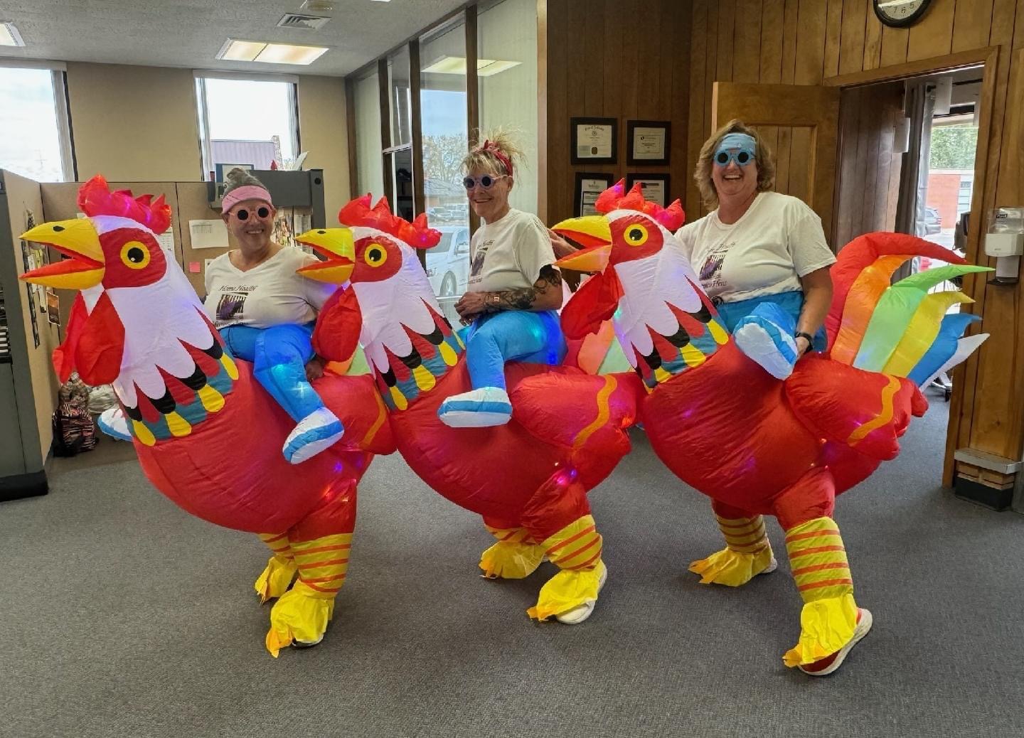 three staff dressed as chickens